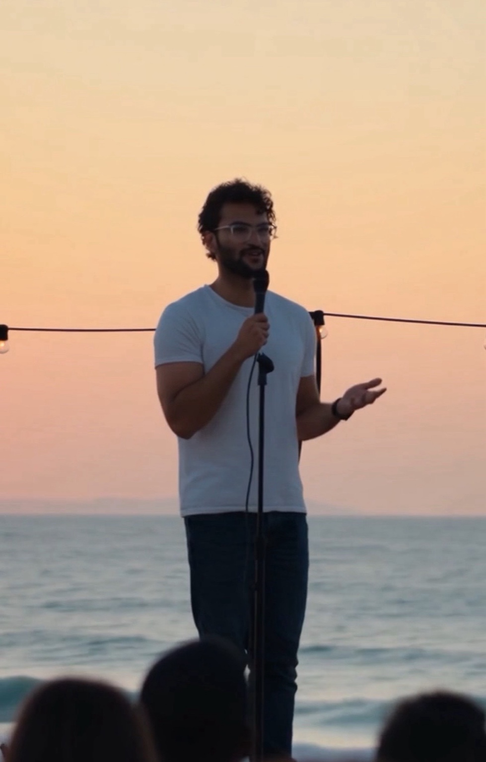 Sean performing at sunset with ocean in background